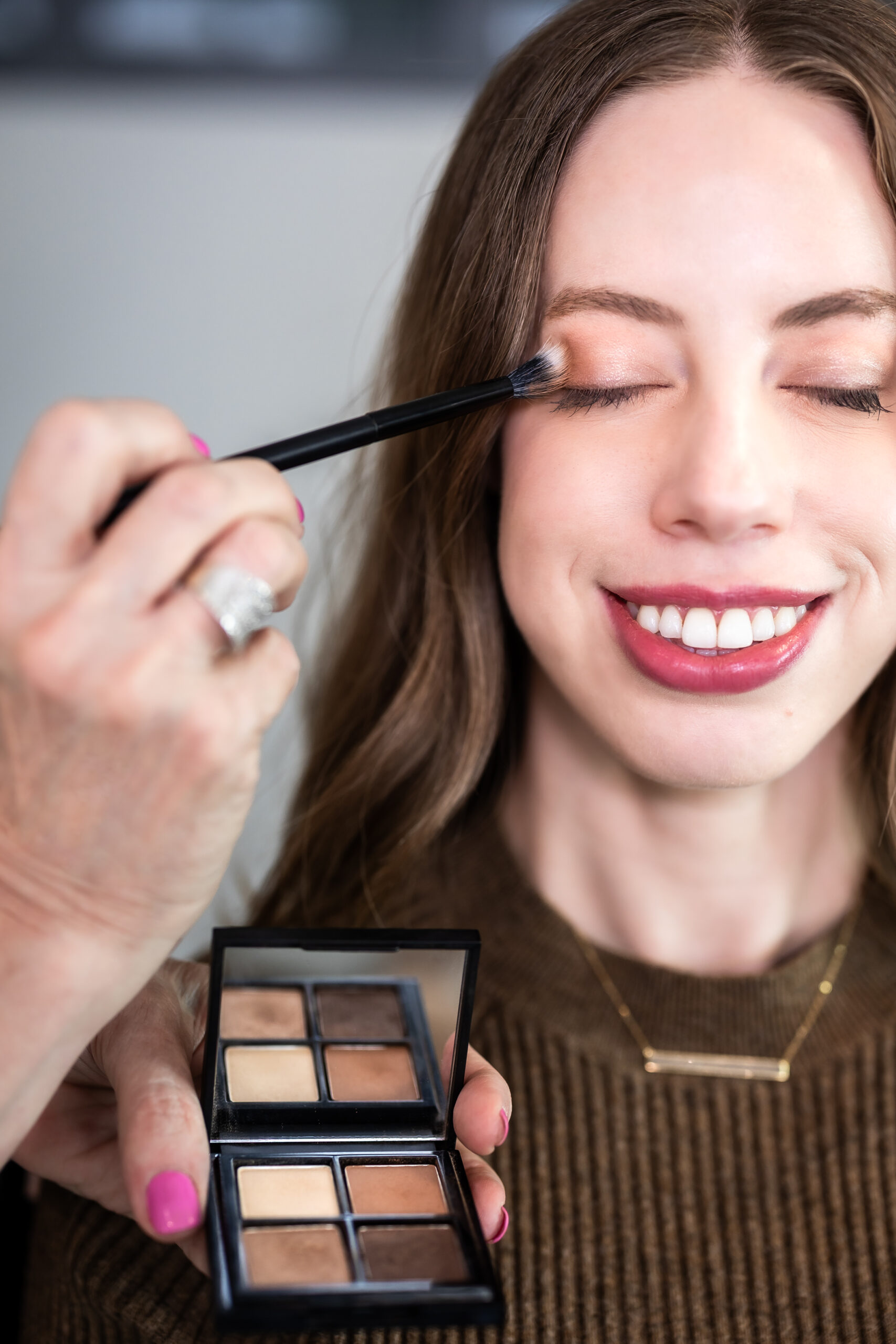 The Honest Image Marla Hursig applying minimalist makeup routine to a young professional