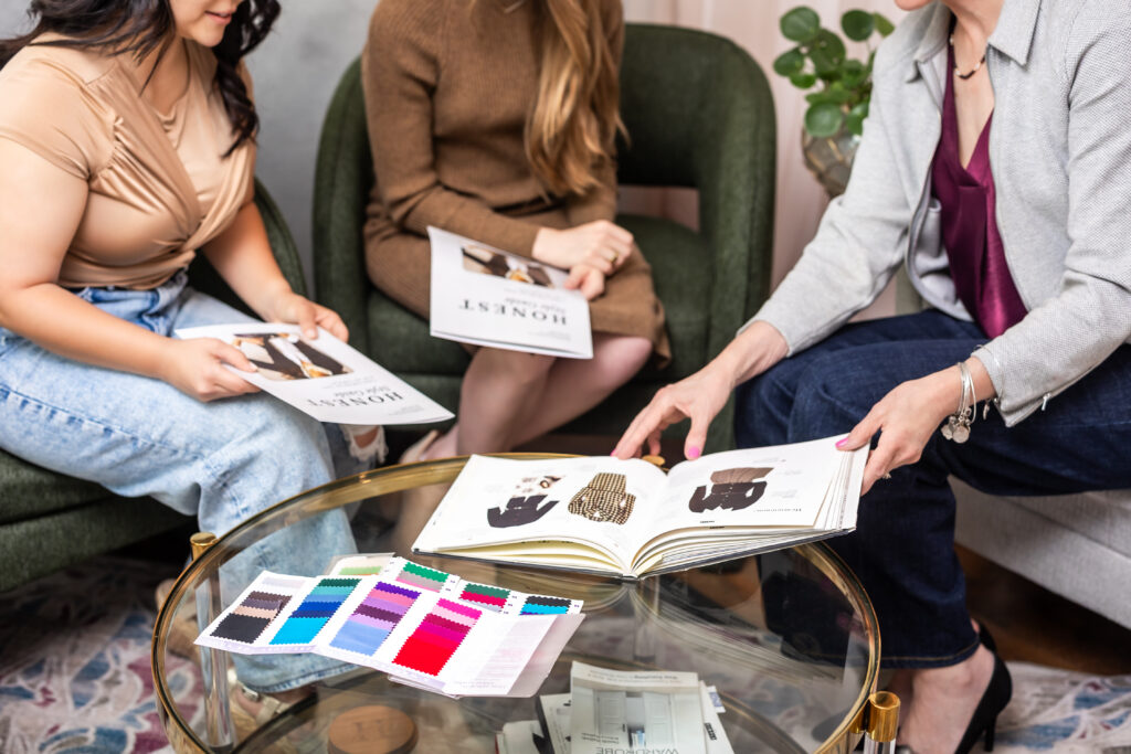 A group of women looking at color swatches and style guides at The Honest Image color analysis in Albuquerque