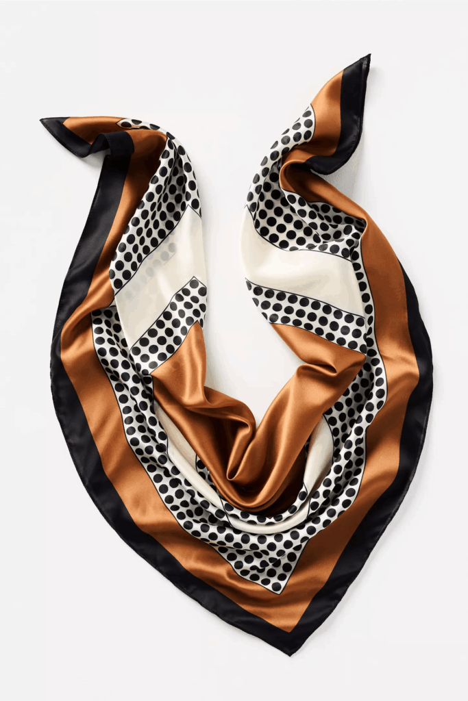 Light scarf with gold, brown and polka dots design.