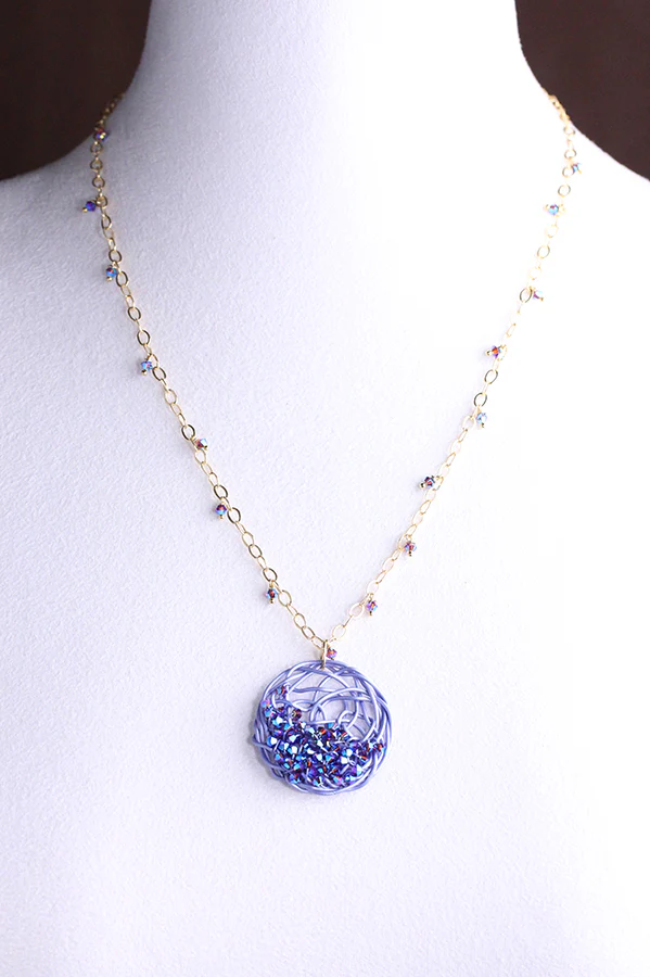 Lavender blue necklace with disc and wire design. 