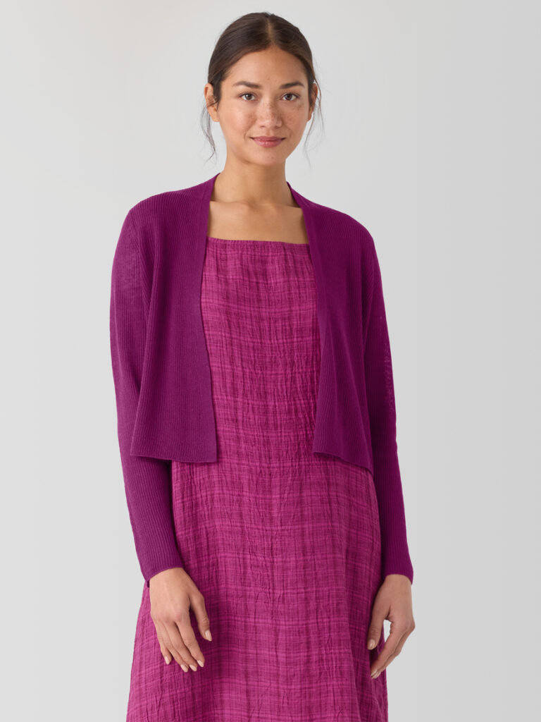 Model is wearing violet dress and bolero. 