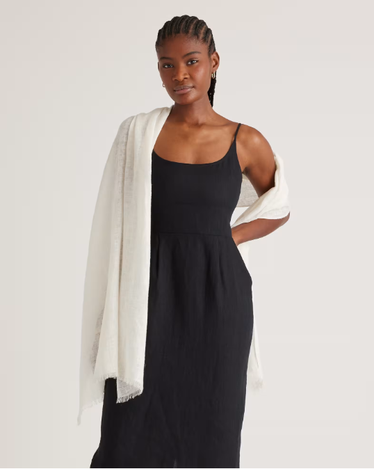 Woman wearing black dress and paired it with a white scarf.