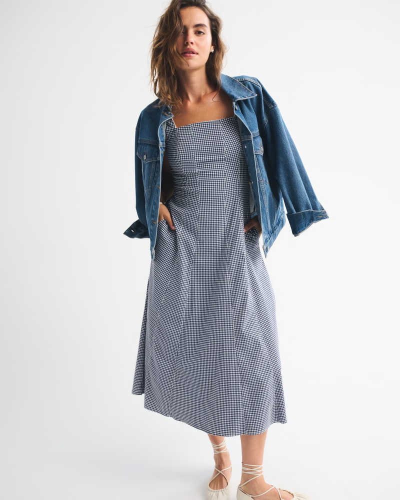 Model wearing dress with jacket on top. 