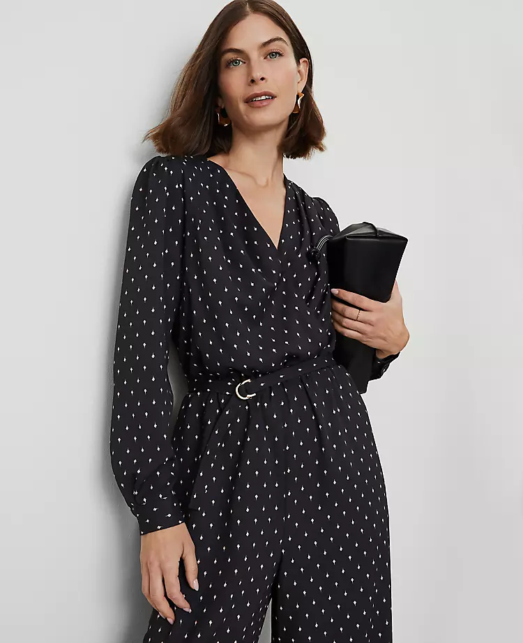 The model elegantly wears a polka dot jumpsuit. 