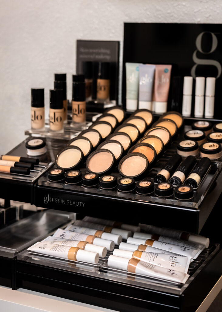 Makeup organizer stand filled with various cosmetics and beauty products.