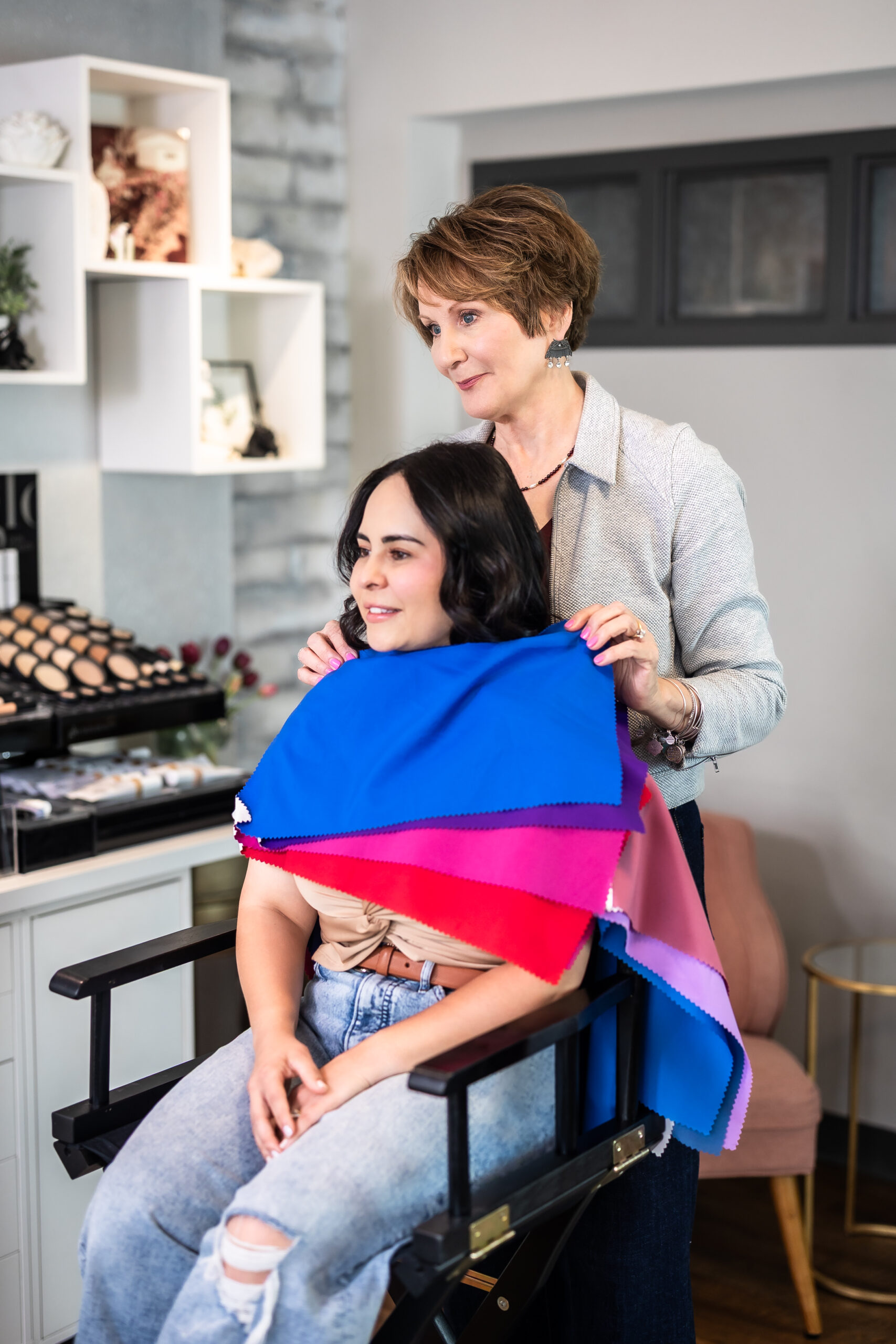 Marla guiding her client to find the most flattering color palette for her personal style.