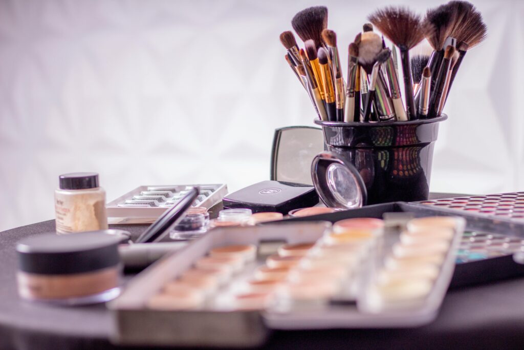 Makeup brushes and a palette arranged on a table.