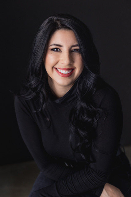 A professional headshot featuring a model with full makeup.