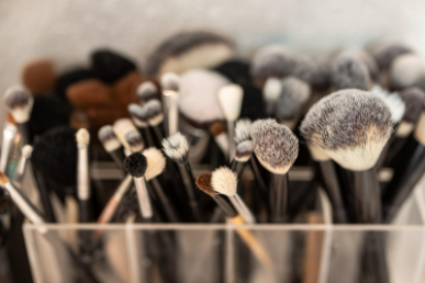 Set of makeup brushes in a large holder.