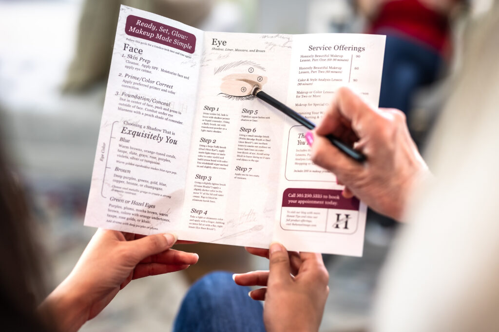 Marla guiding a client through makeup products during a session in Albuquerque.