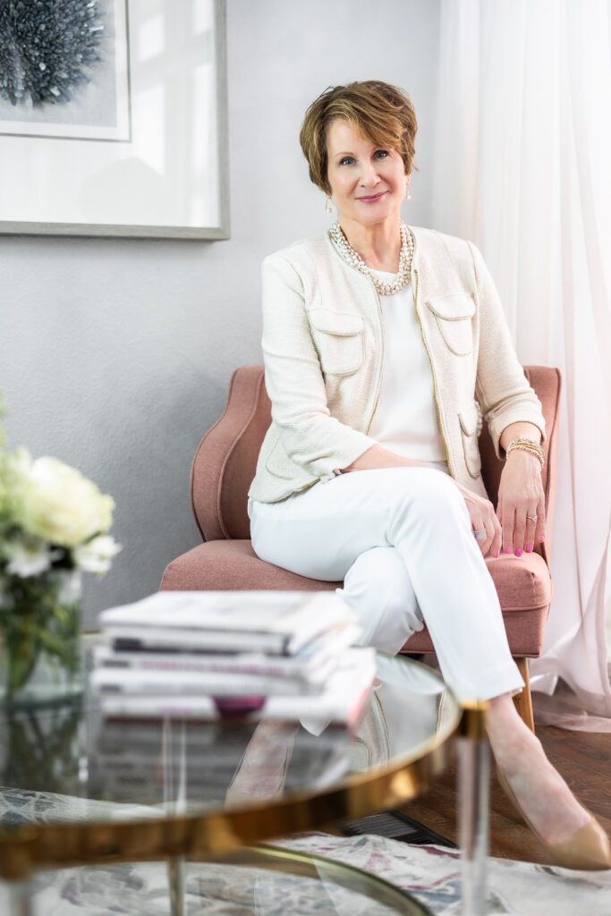 Marla, owner of The Honest Image, seated in a chair.