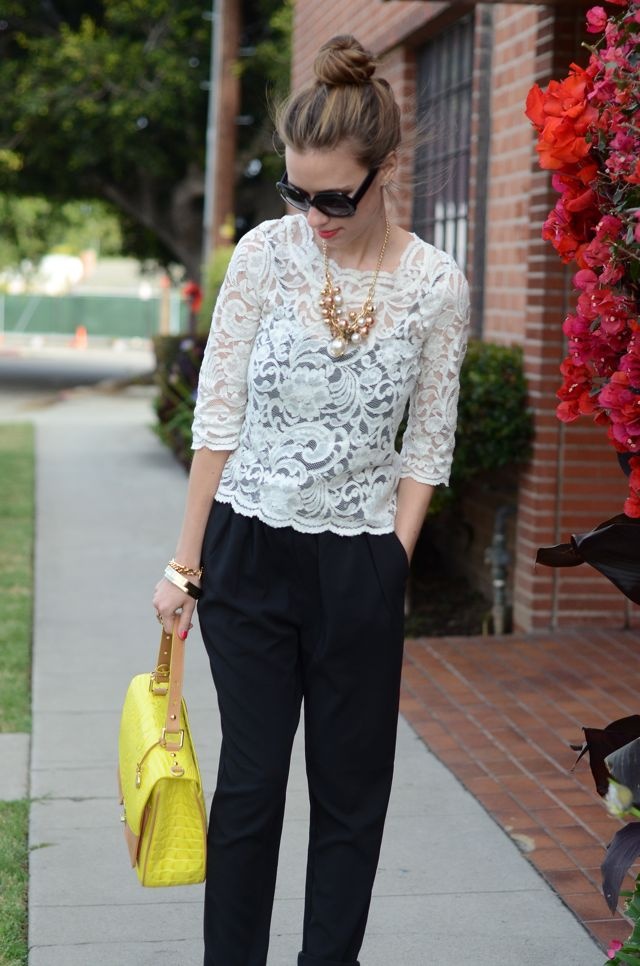 Woman wearing neutral clothes with yellow bag adding pop to her outfit.