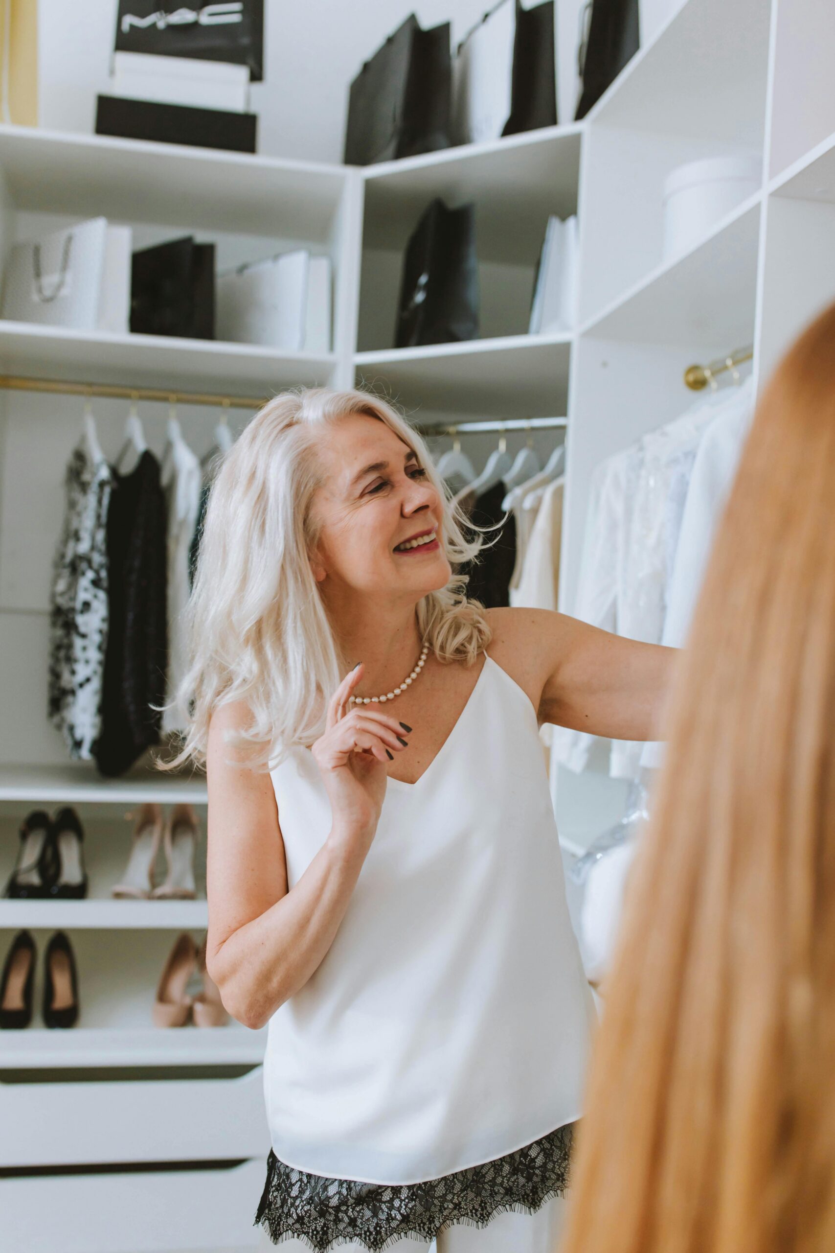 A woman looking through clothes in her closet