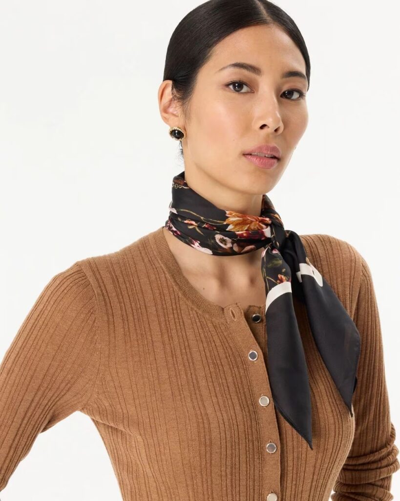 Floral scarf styled as an accent to a fashionable outfit