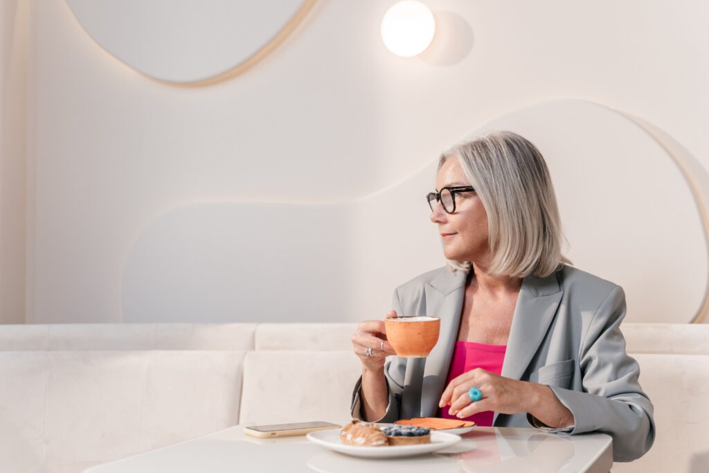 Woman enjoying food and coffee at a café.
